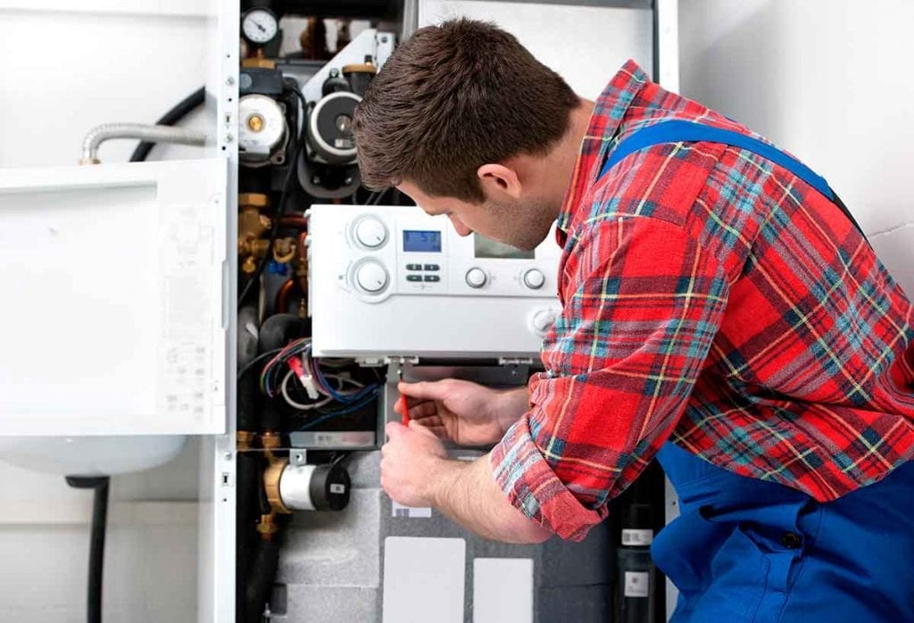 Plumber servicing a boiler in huddersfield