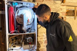 Gas Engineer Diagnosing boiler issue